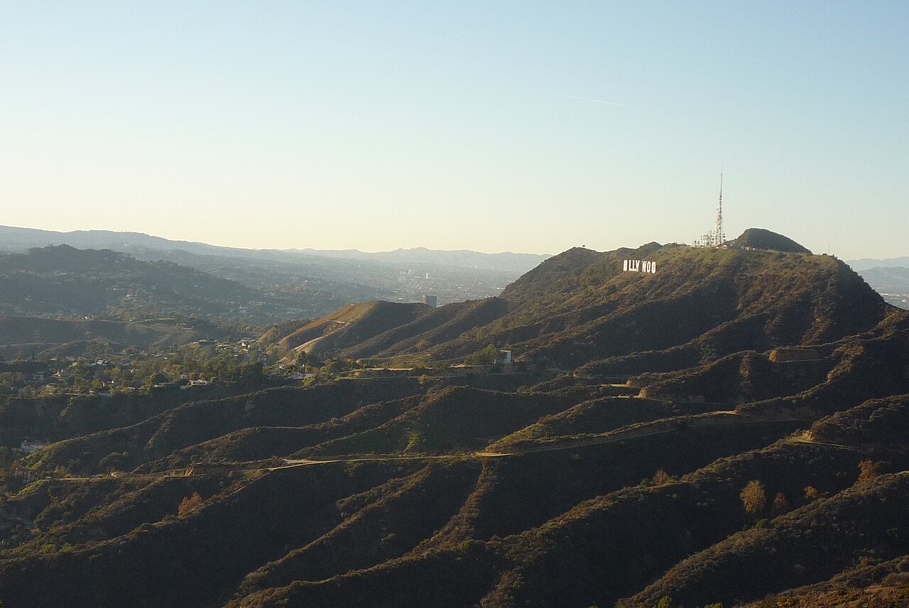 Sunlit ridges in Griffith Park with the Hollywood Sign on a distant hillside