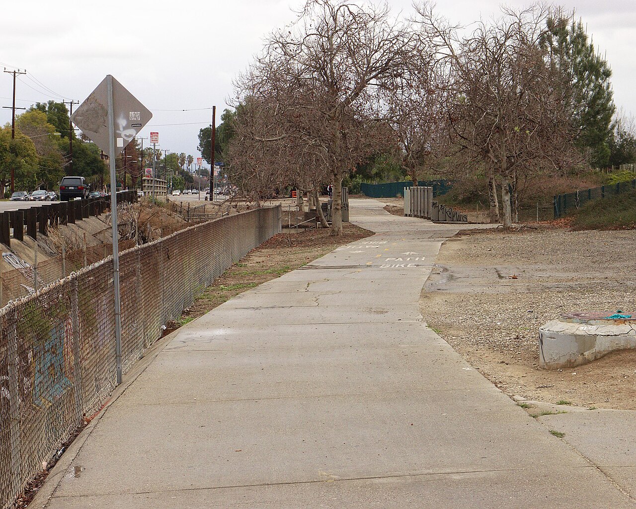 Paved G Line bikeway beside Victory Boulevard, with the adjacent road visible